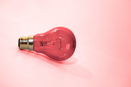 a red lightbulb on a clean background depicting pornの写真素材