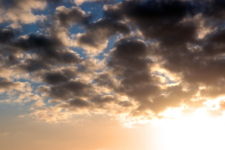 rays of sunshine against a cloudy blue sky