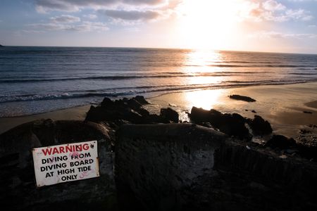 a warning sign on the cliffs in youghal county cork irelandの写真素材