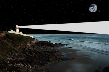 lighthouse captured on the high ground overlooking the cliffs at nightの写真素材