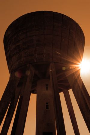 a water tower in the irish countryside on a hot day with a white background in sepiaの写真素材