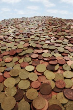 lots of loose change in euro cents and other coins like a mountain