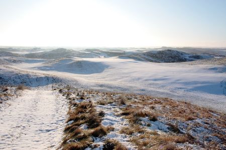 snow covered links golf course in ireland in winter の写真素材