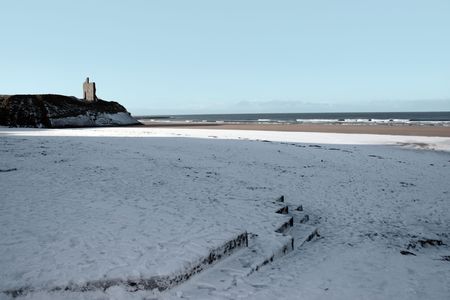winters beach view of the castle overlooking the beach in ballybunion co kerry irelandの写真素材