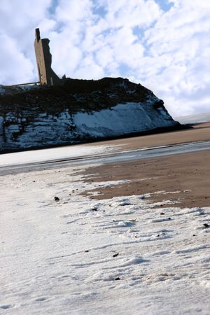 winters beach view of the castle overlooking the beach in ballybunion co kerry irelandの写真素材