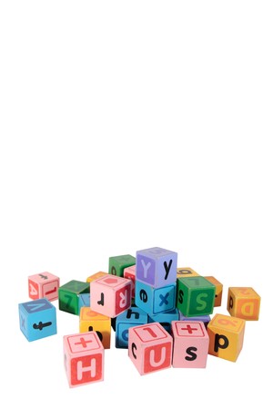 assorted childrens toy letter building blocks against a white background with copy spaceの写真素材