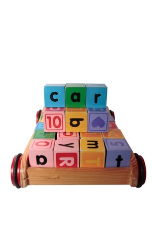 childrens toy letter building blocks all together in a toy cart isolated on white backgroundの写真素材