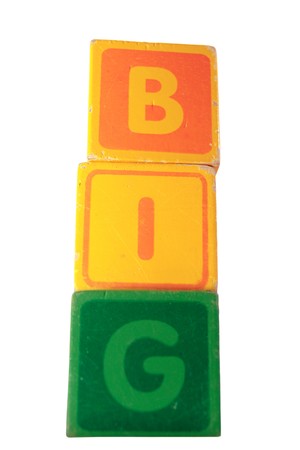 childrens toy letter building blocks against a white background spelling bigの写真素材