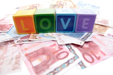 assorted childrens toy letter building blocks on money that spell loveの写真素材