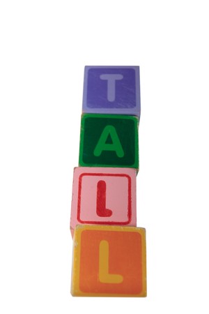 childrens toy letter building blocks against a white background spelling tall の写真素材