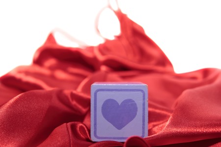 love heart on block on a silk nightie against white backgroundの写真素材