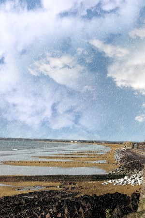 beach during a rain storm on the rocks in youghal county cork irelandの写真素材