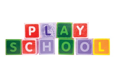 assorted childrens toy letter building blocks against a white background that spell playschool の写真素材