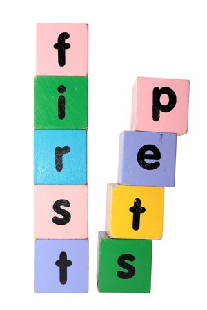 toy letters that spell first step against a white background の写真素材