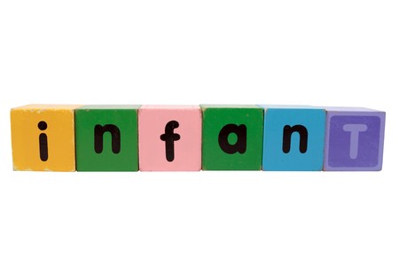 toy letters that spell infant against a white background の写真素材