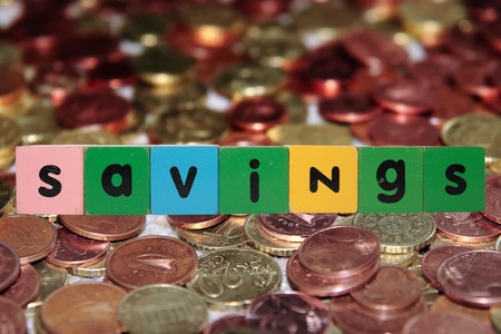 toy letters that savings against a coin background