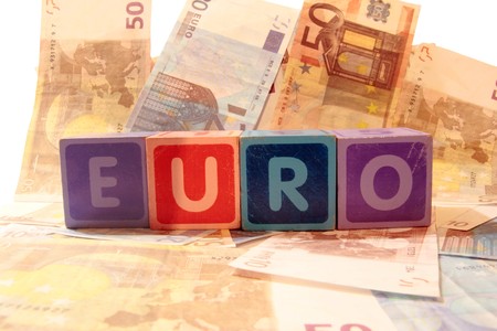 toy letters that spell euro against a cash background の写真素材