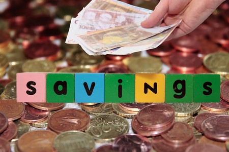 toy letters that savings against a money background の写真素材