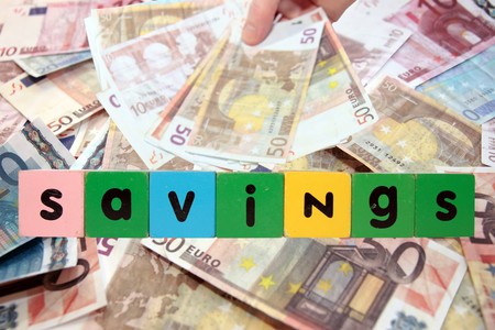 toy letters that savings against a money background の写真素材