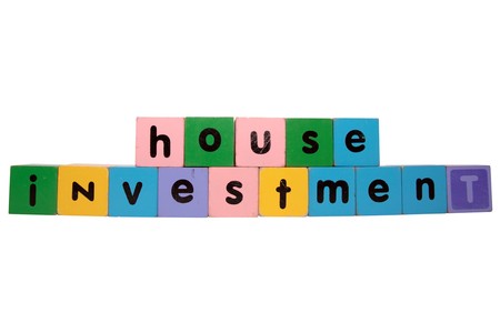 toy letters that spell house investment against a white background の写真素材