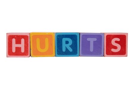 toy letters that spell hurts against a white background の写真素材