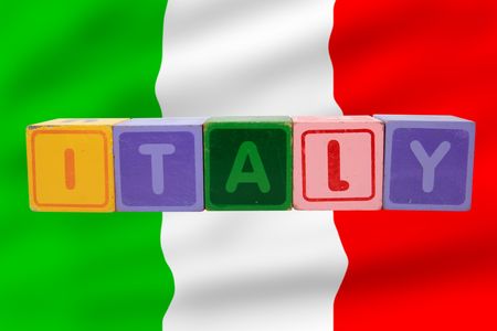 toy letters that spell italy against a flag background の写真素材