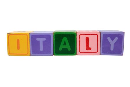 toy letters that spell italy against a white backgroundの写真素材