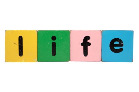 toy letters that spell life against a white backgroundの写真素材