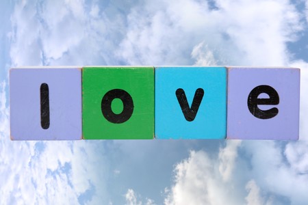 toy letters that spell love against a cloudy background の写真素材