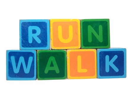 toy letters that spell walk and run against a white backgroundの写真素材