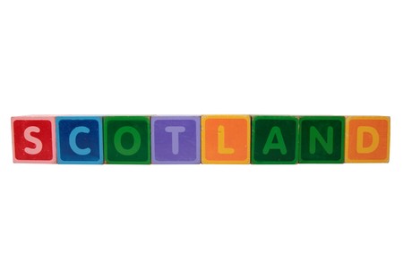 toy letters that spell scotland against a white background の写真素材
