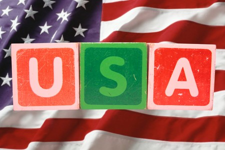 toy letters that spell usa against a flag background の写真素材