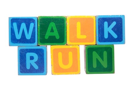 toy letters that spell walk and run against a white background の写真素材