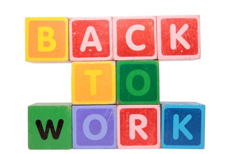 toy letters that spell back to work against a white background の写真素材