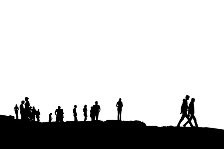 Silhouette of crowd of people on the peak or edge of a cliff in irelandの写真素材