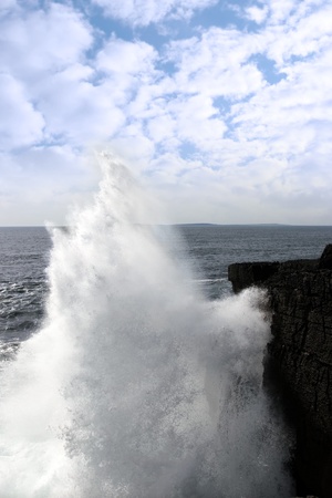 cliffs and coastline of the burren in county clare ireland with giant waves crashing on the rocksの写真素材