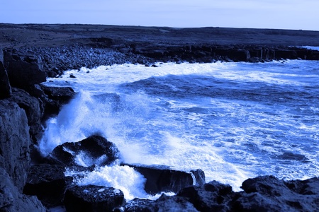 cliffs and coastline of the burren in county clare ireland with waves crashing on the rocksの写真素材