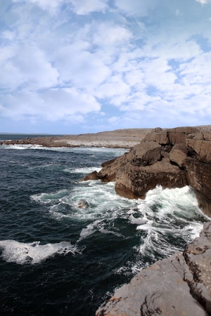 cliffs and coastline of the burren in county clare ireland with waves crashing on the rocksの写真素材