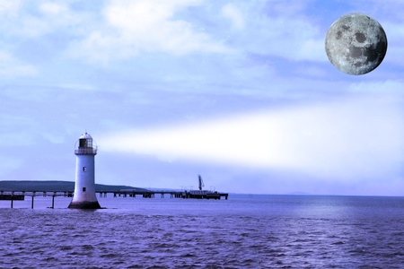 a lighthouse on the mouth of the river shannon with a full moonの写真素材