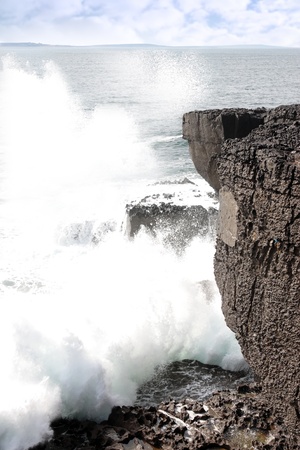 cliffs and coastline of the burren in county clare ireland with waves crashing on the rocksの写真素材