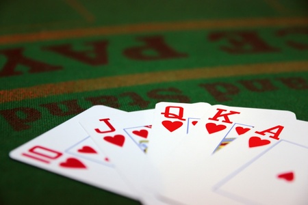 green casino table with a hand of a royal flush in a poker gameの写真素材