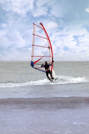 person windsurfing in the maharees in county kerry ireland during a stormの写真素材