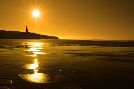 a scenic view of a castle on the irish coastline at ballybunion at sunsetの写真素材