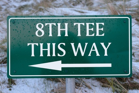 8th tee this way sign on a snow covered links golf course in ireland in snowy winter weatherの写真素材