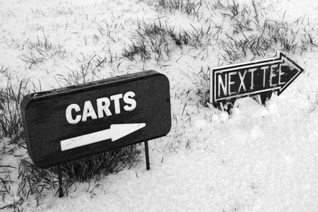 carts and next tee sign on a snow covered links golf course in ireland in snowy winter weatherの写真素材
