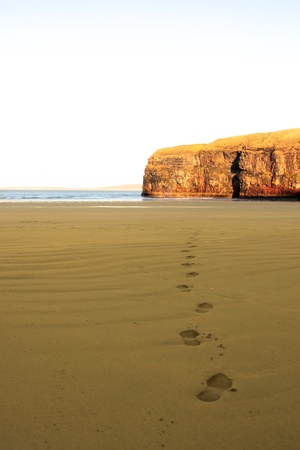 footprints on an empty beach on a beautiful winters dayの写真素材