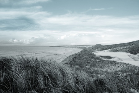 atlantic ocean beside a snow covered links golf course in ireland in snowy winter weatherの写真素材