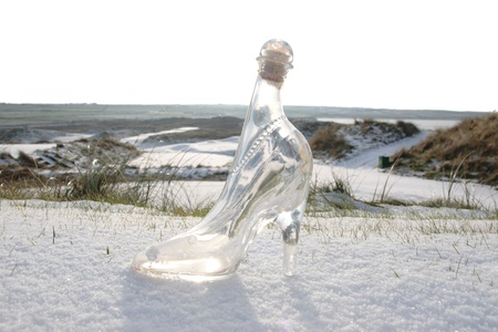 a crystal glass slipper in a snow covered irish golf course for a concept on ladies golfの写真素材