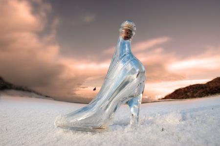 a glass slipper in a snow covered irish golf course for a concept on ladies golfの写真素材