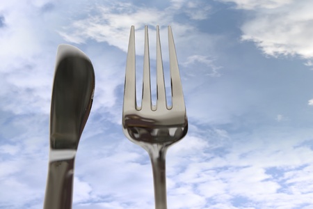 fork isolated against a cloud background with copy space on right as in eating outの写真素材